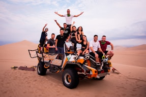a group of people riding on the back of a four wheeler