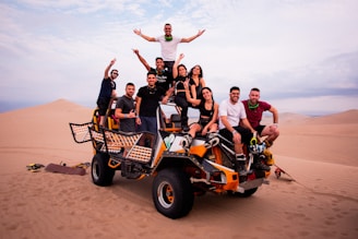 a group of people riding on the back of a four wheeler