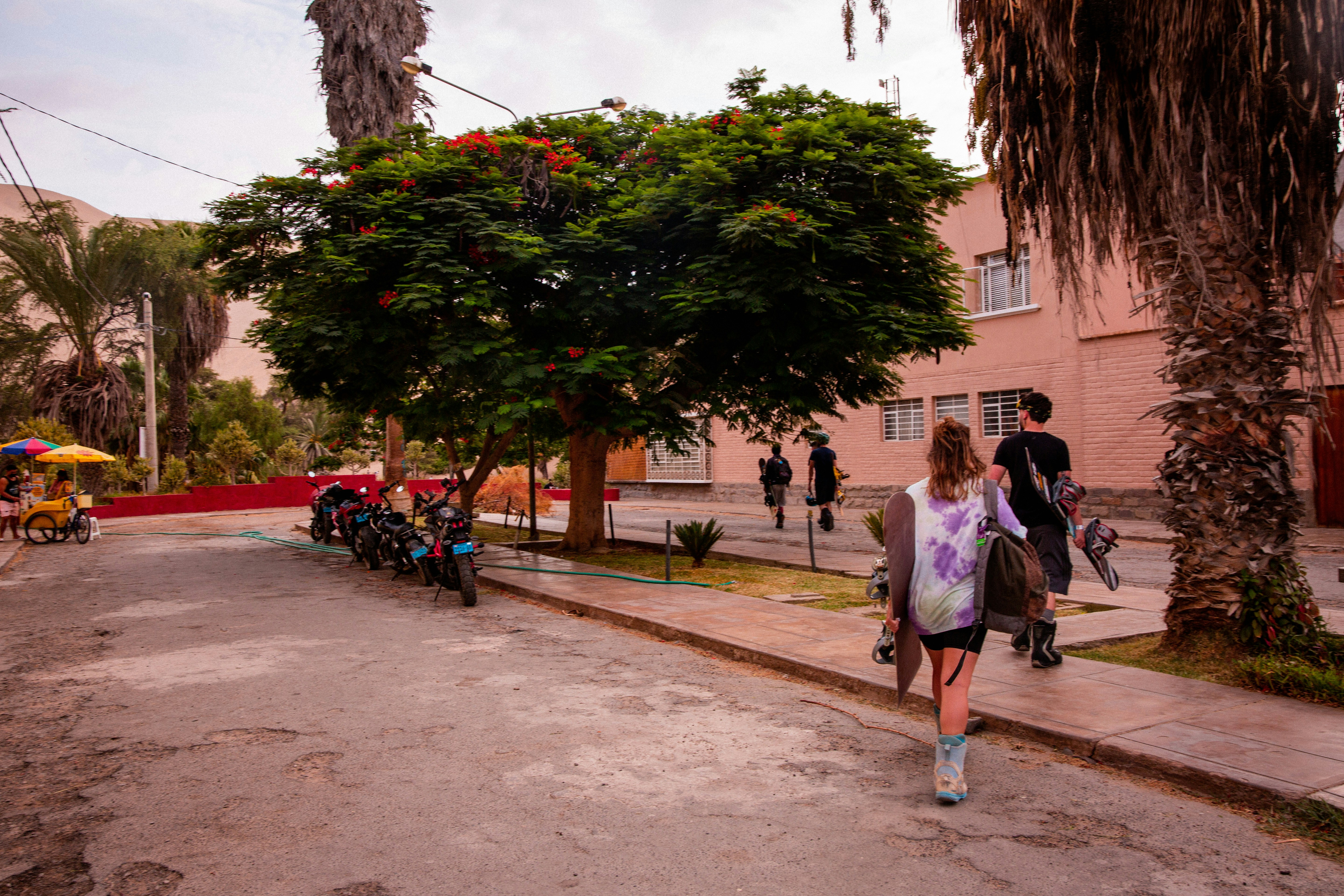 a woman is walking down the street with an umbrella