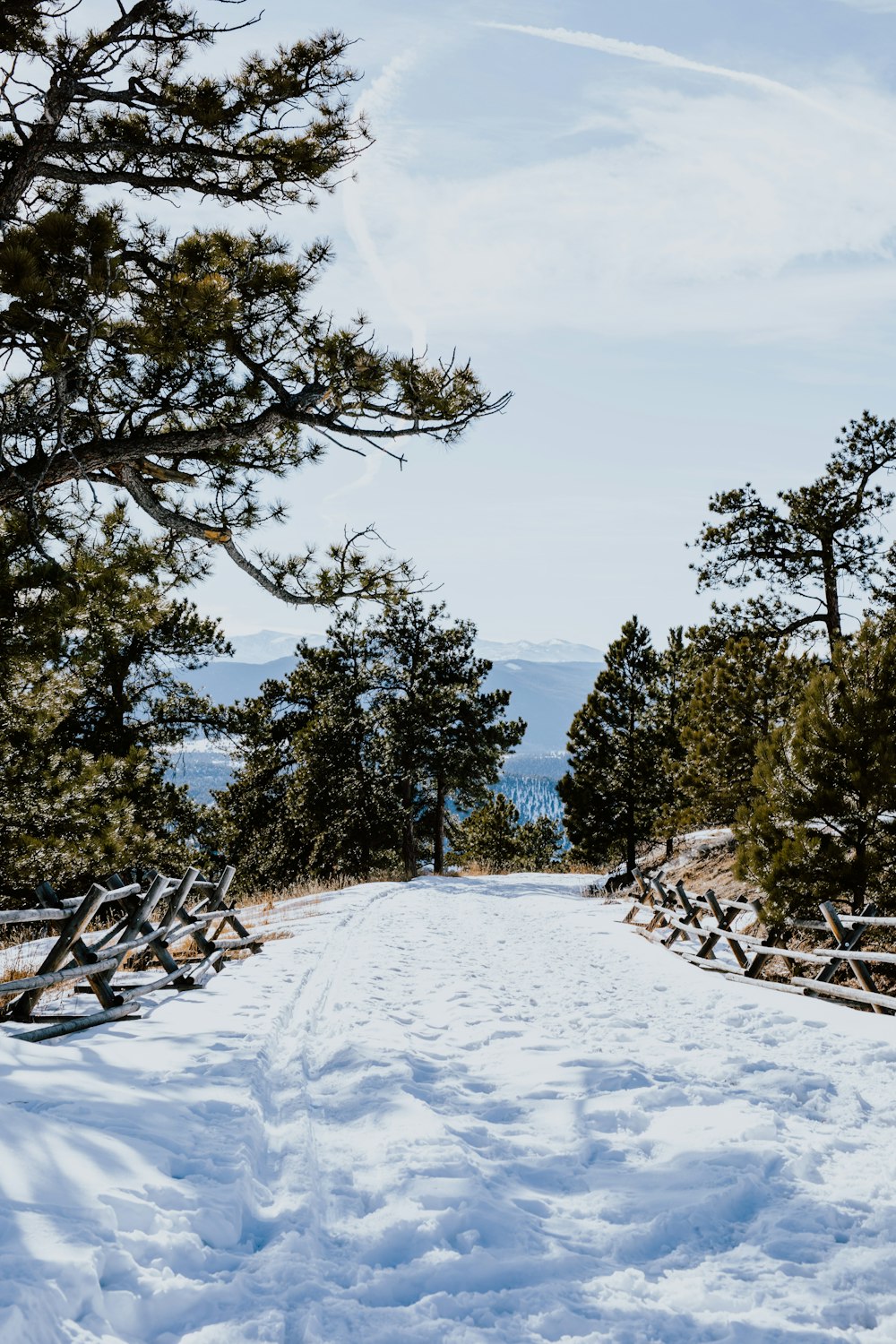 a snow covered path leading to the top of a mountain