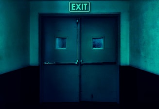 an exit sign above a door in a dark room