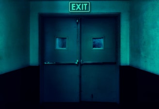 an exit sign above a door in a dark room