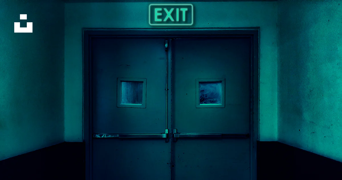 Exit Sign For Rooom An exit sign above a door in a dark room photo – Free Door Image on ...