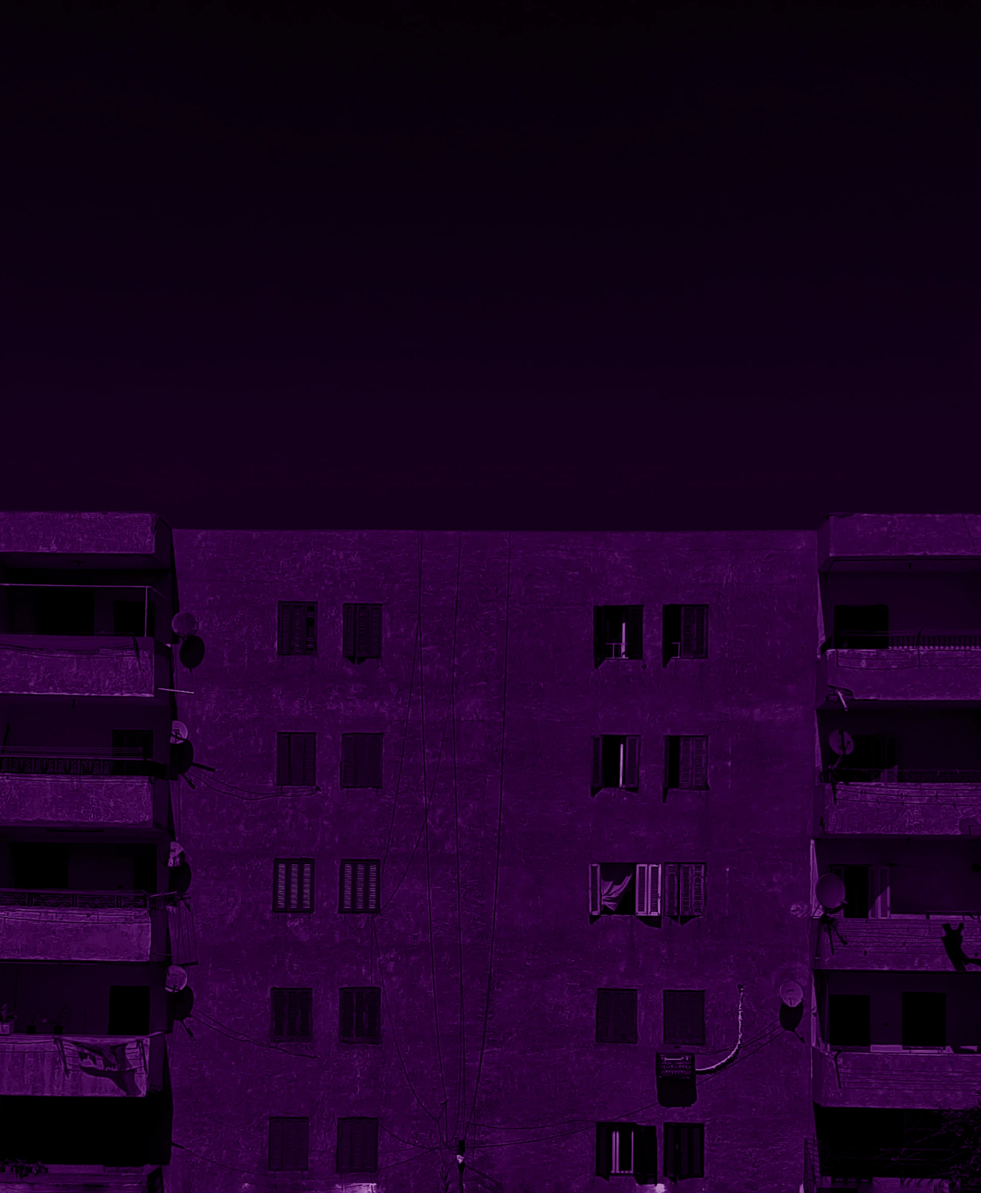 a tall building with balconies and a clock tower