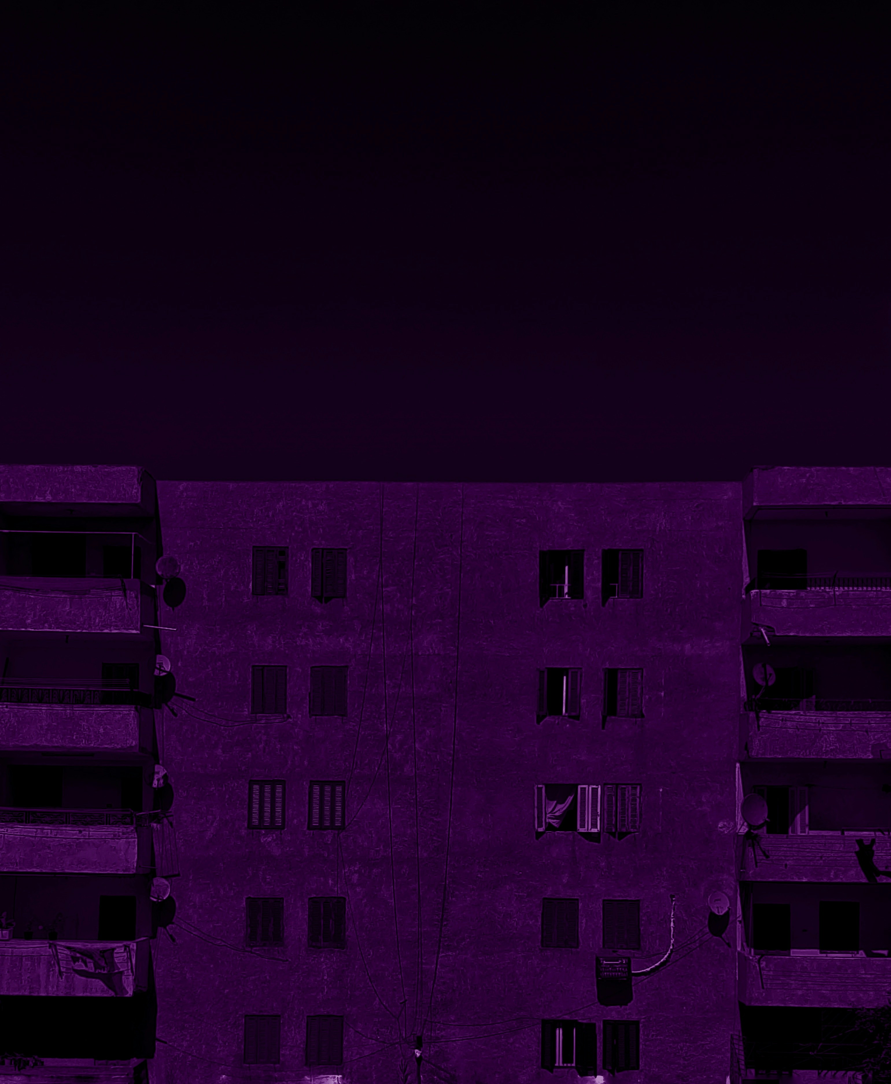 a tall building with balconies and a clock tower