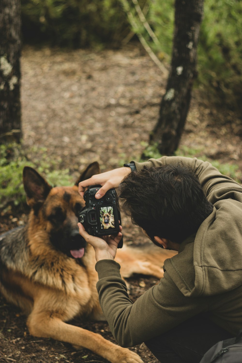 a man taking a picture of a dog with a camera