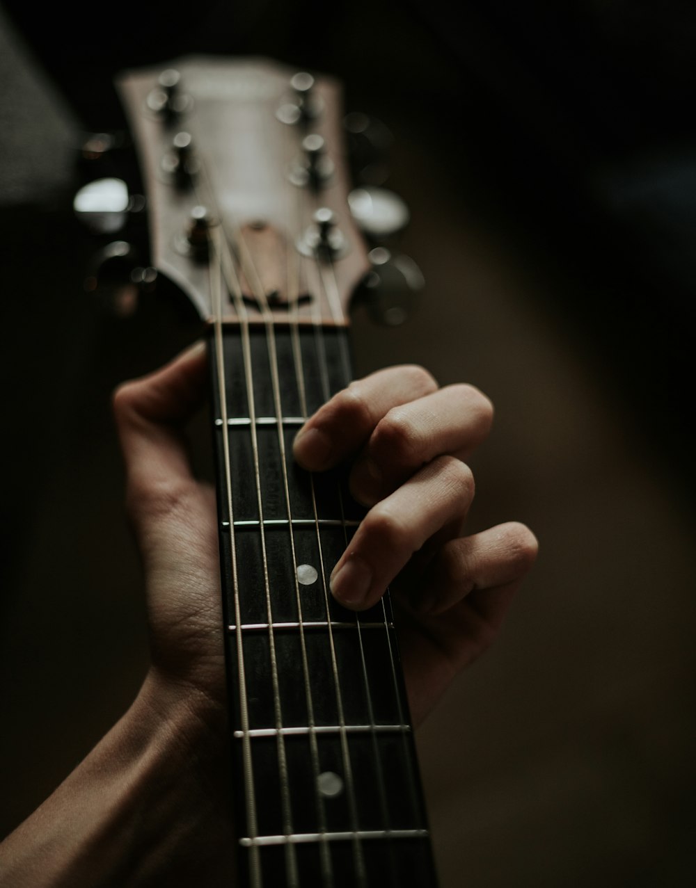 a person holding a guitar in their hand