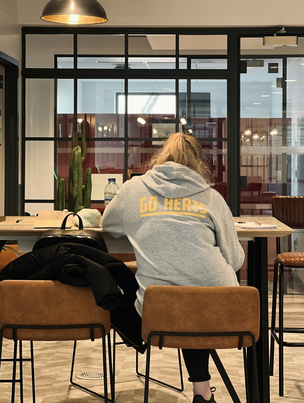 a person sitting at a table with a backpack