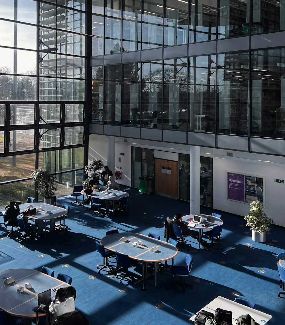 a group of people sitting at tables inside of a building