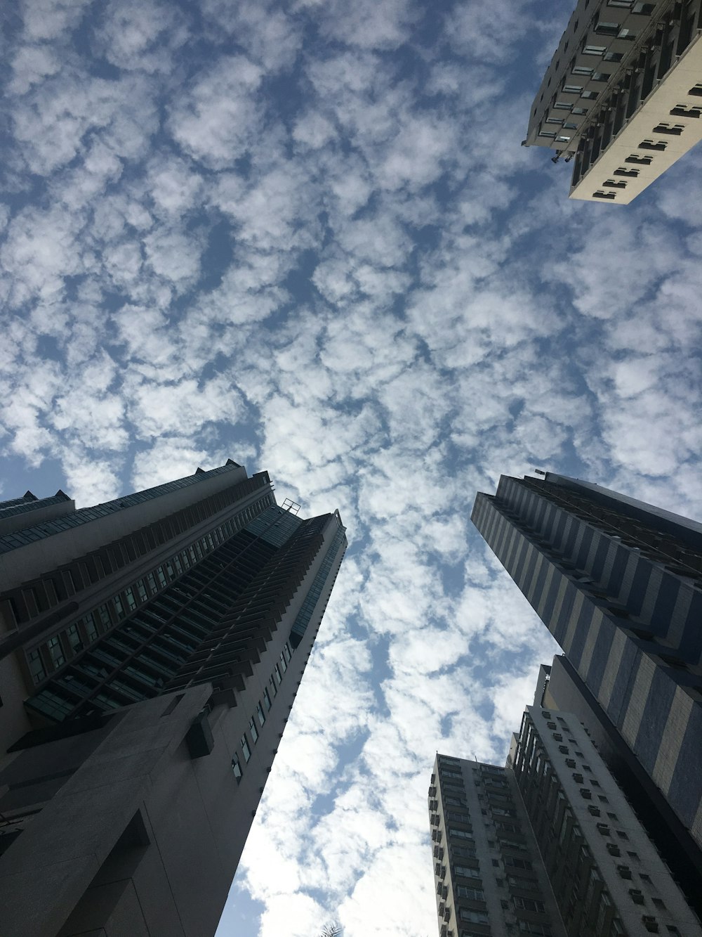 a group of tall buildings with a sky background