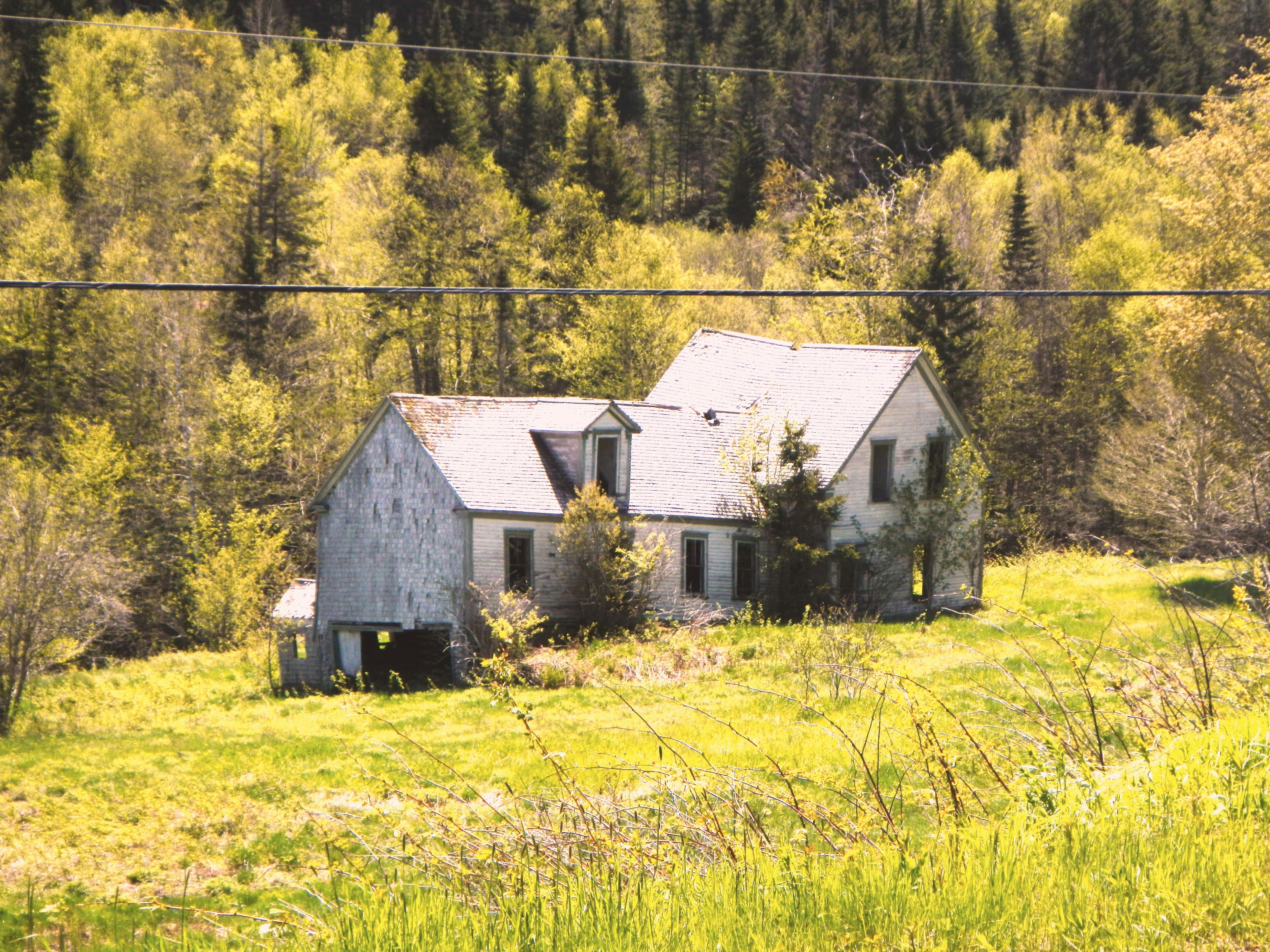 an old house in the middle of a field