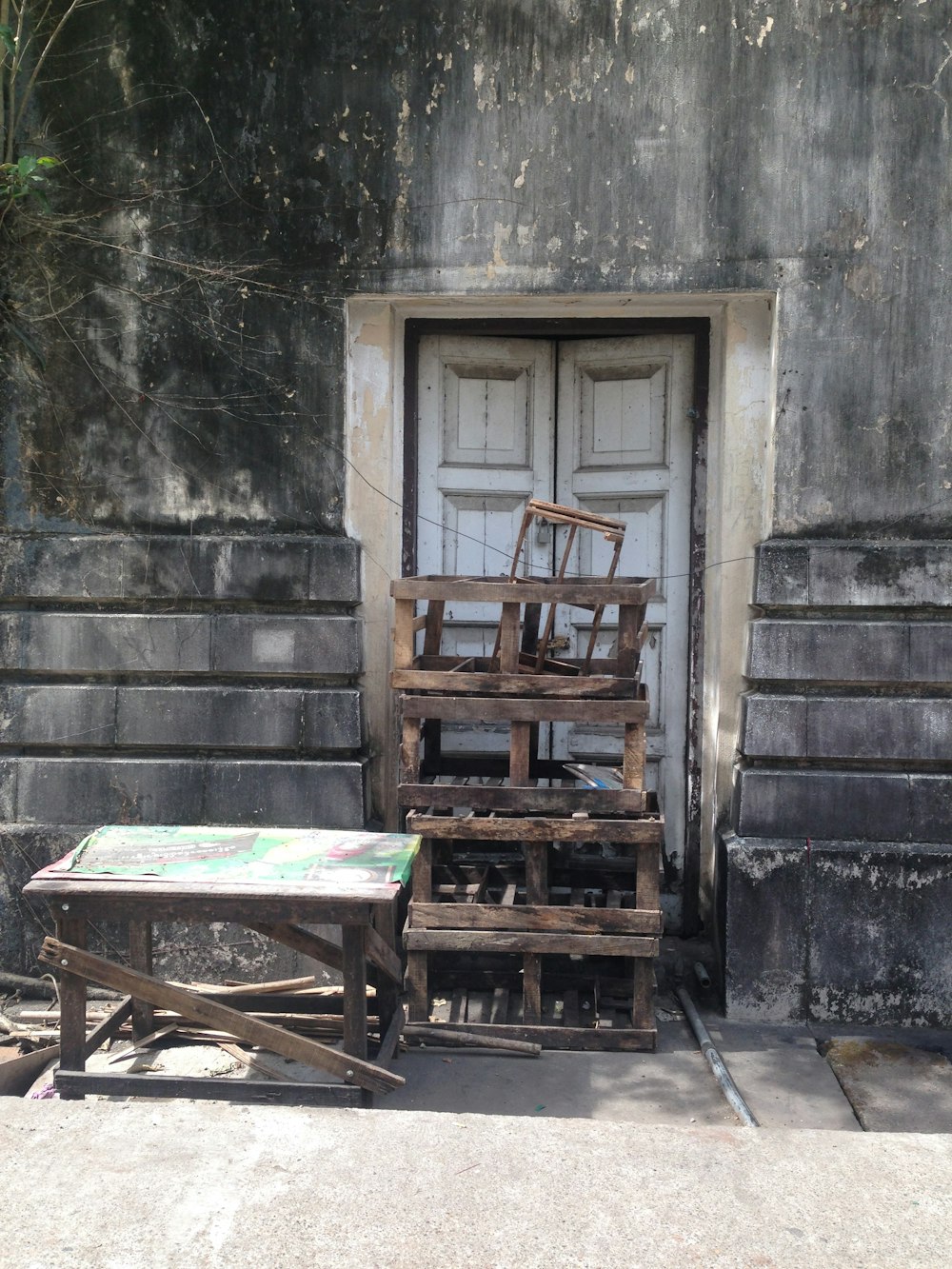 a table and chair sitting in front of a door