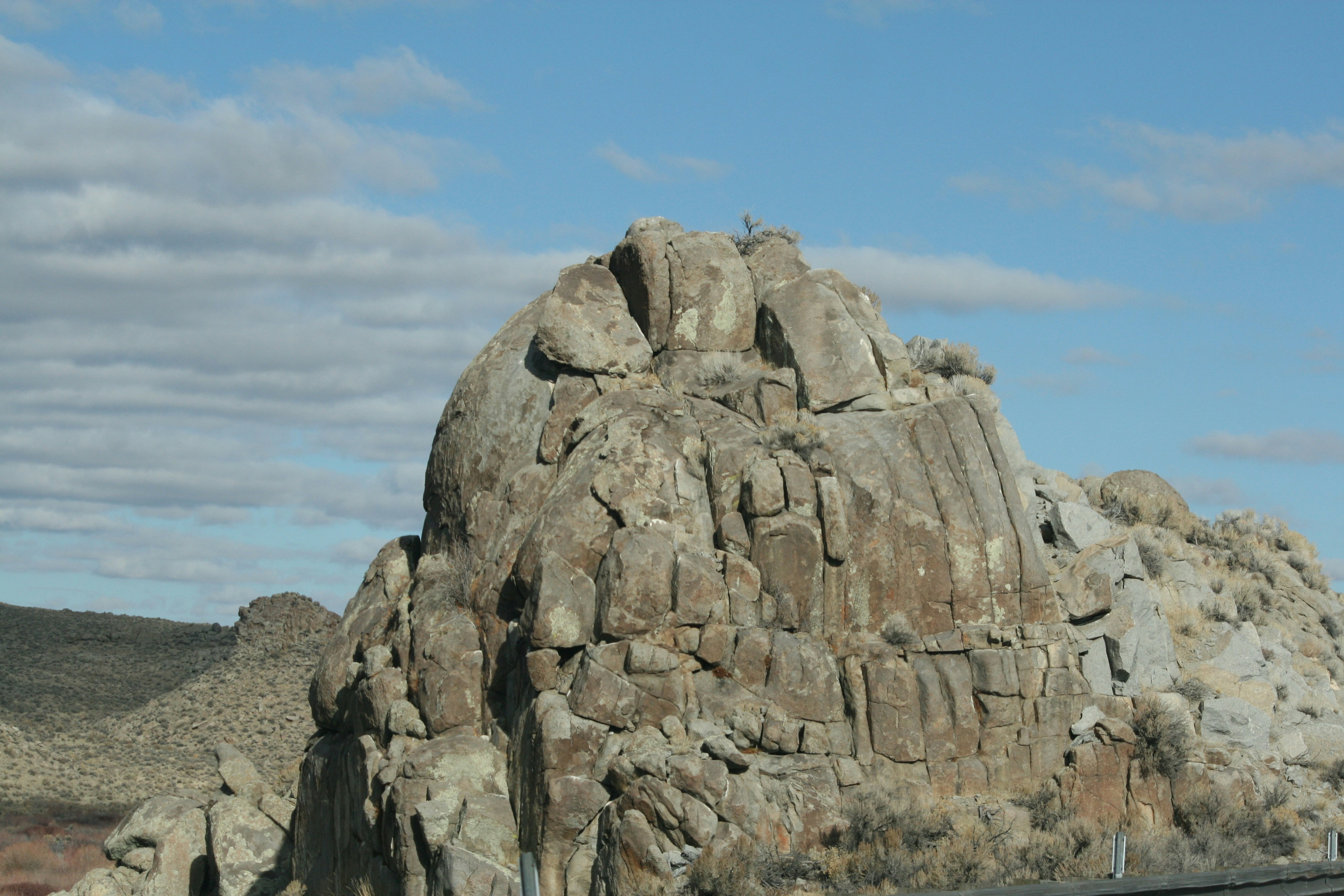 a large rock formation in the middle of a desert