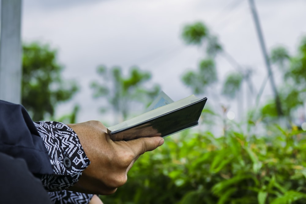 a person holding a book in their hand