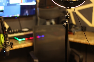 a tripod light sitting on top of a tripod in front of a computer