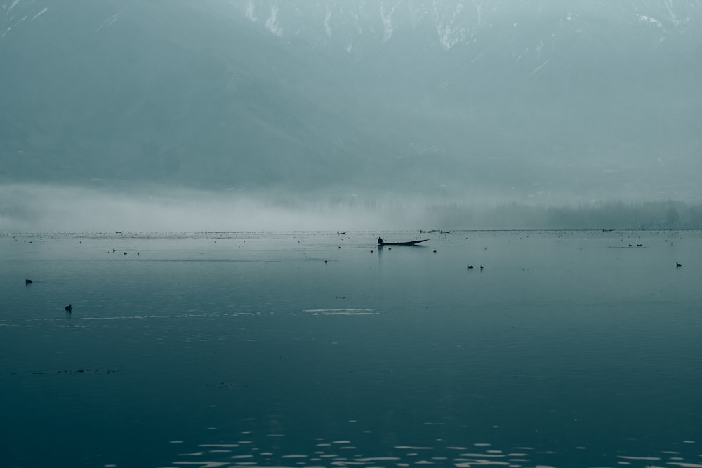 a boat floating on top of a large body of water