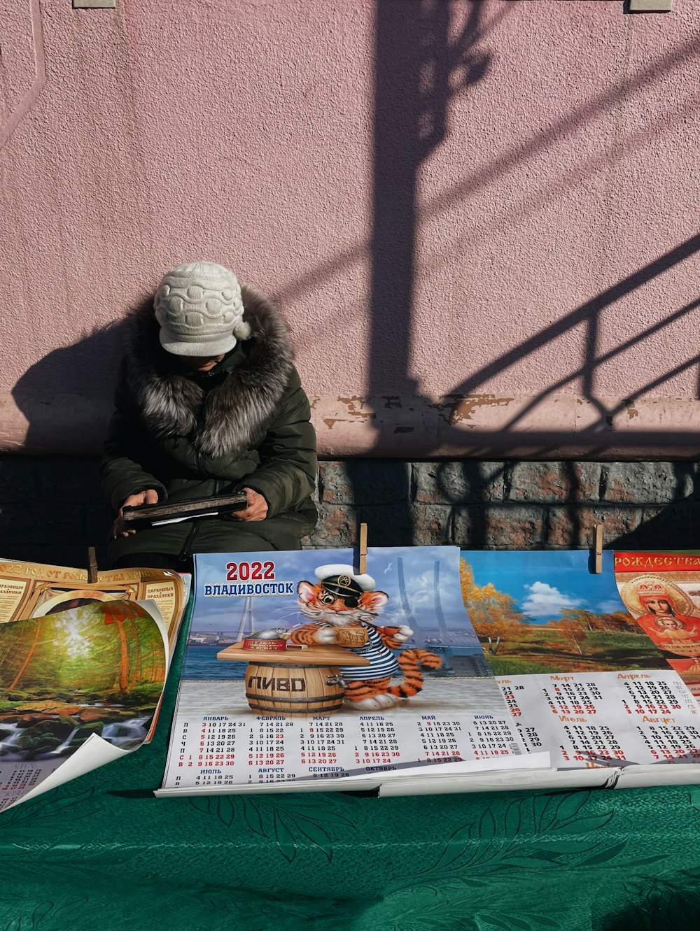 a woman sitting on a bench next to a calendar