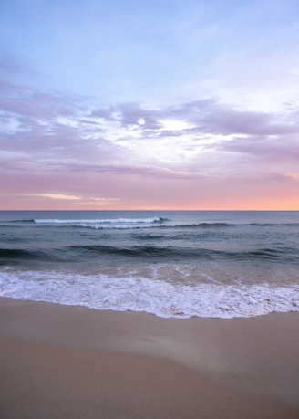 a beach with waves coming in to shore