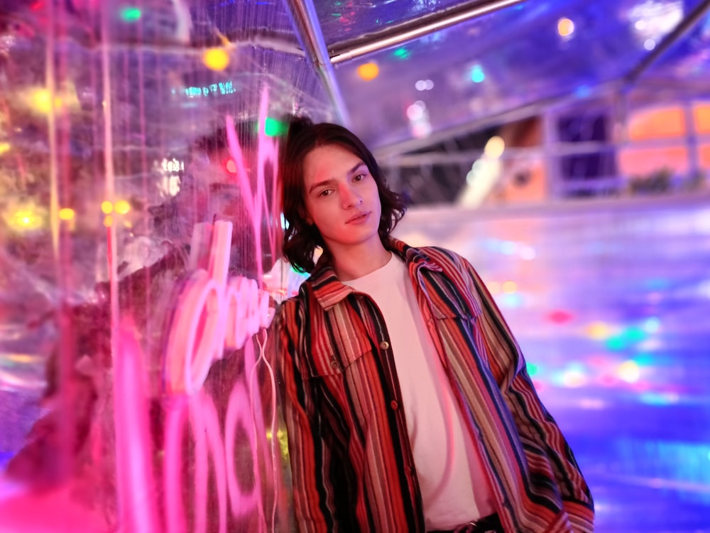 a woman standing in front of a neon display