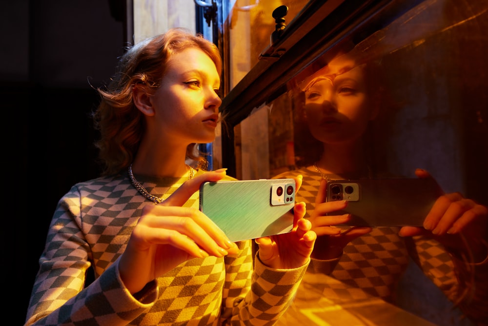 a woman taking a picture of herself in a mirror