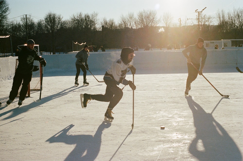 a group of people playing a game of ice hockey