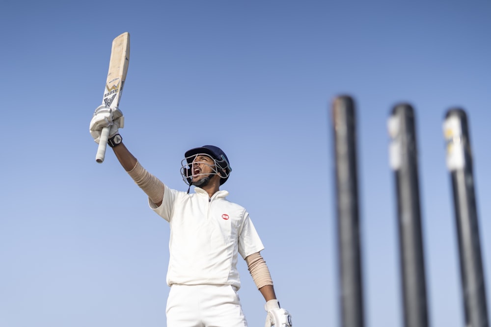 a man holding a bat and wearing a helmet