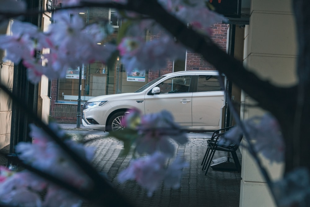 a white car parked in front of a building