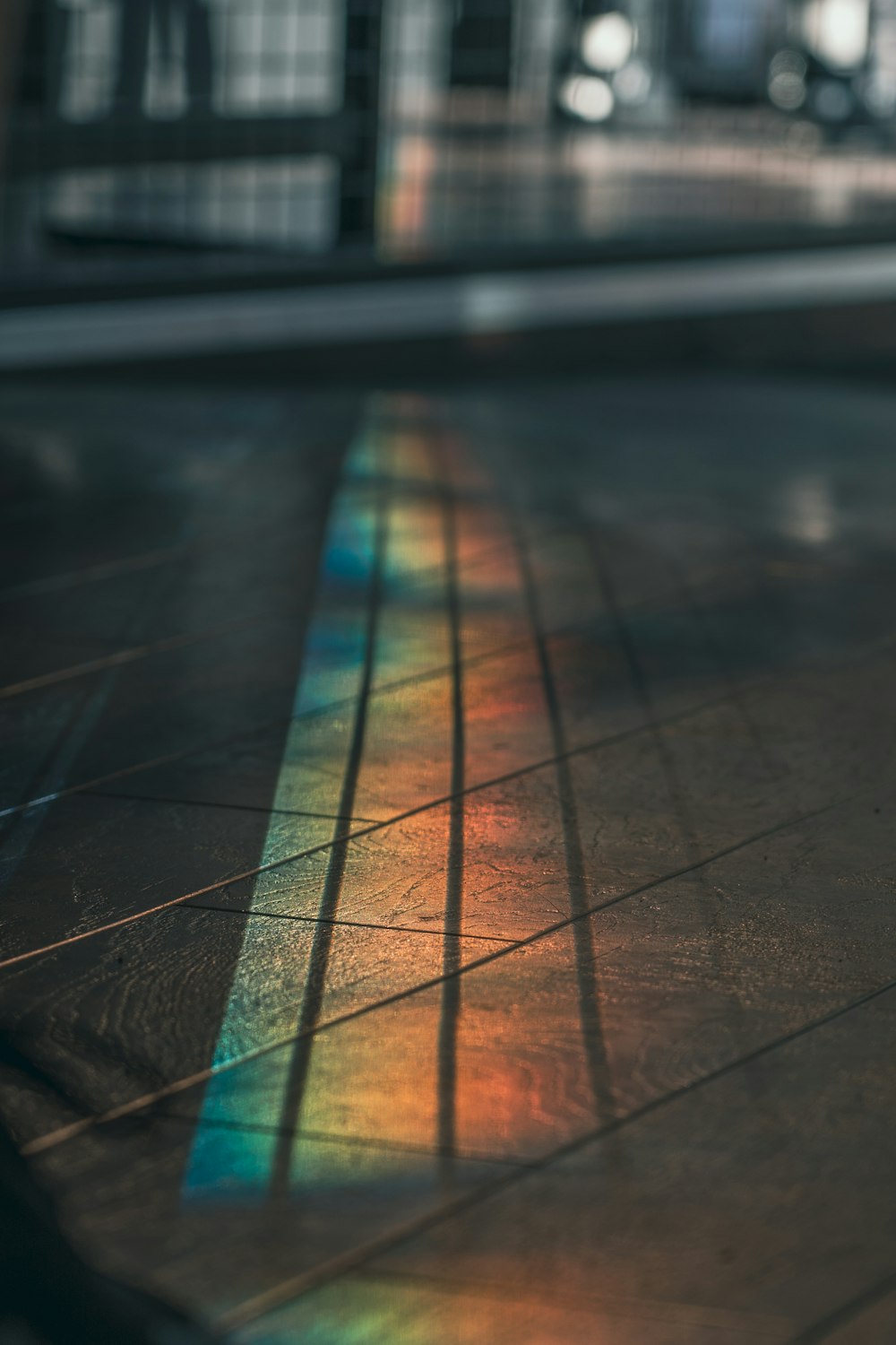 a rainbow of light shining through a glass window