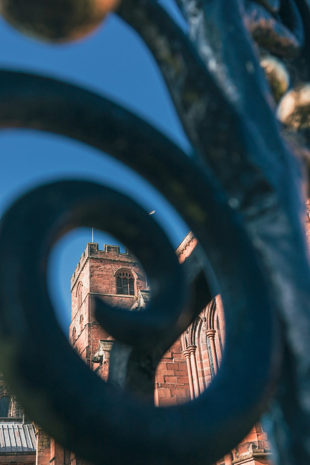 a view of a building through a metal fence