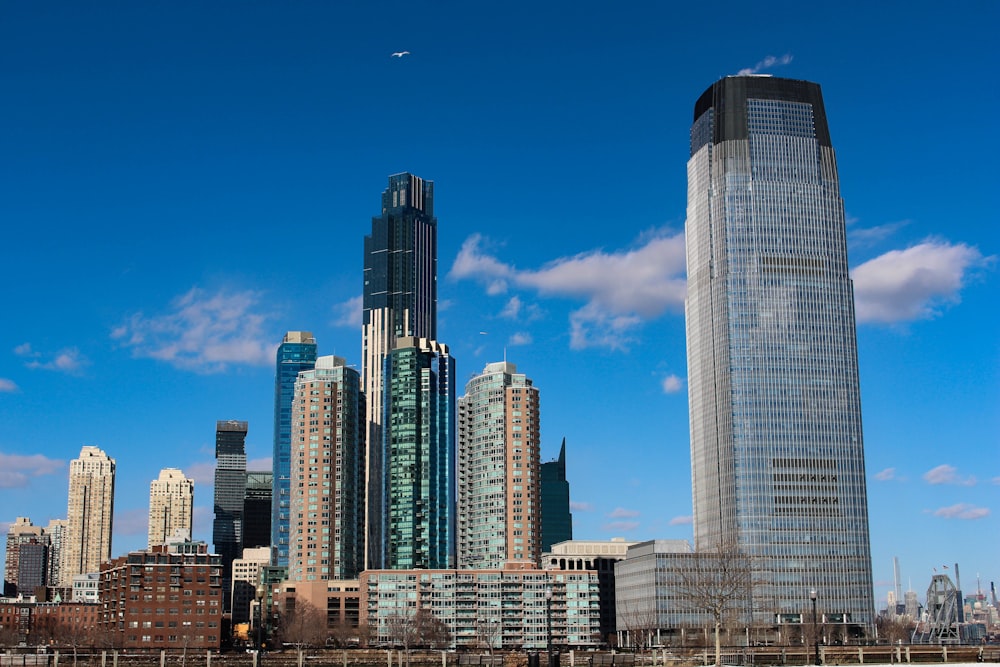 a city skyline with tall buildings in the foreground