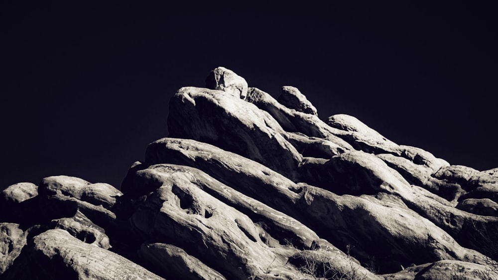 a black and white photo of a rock formation