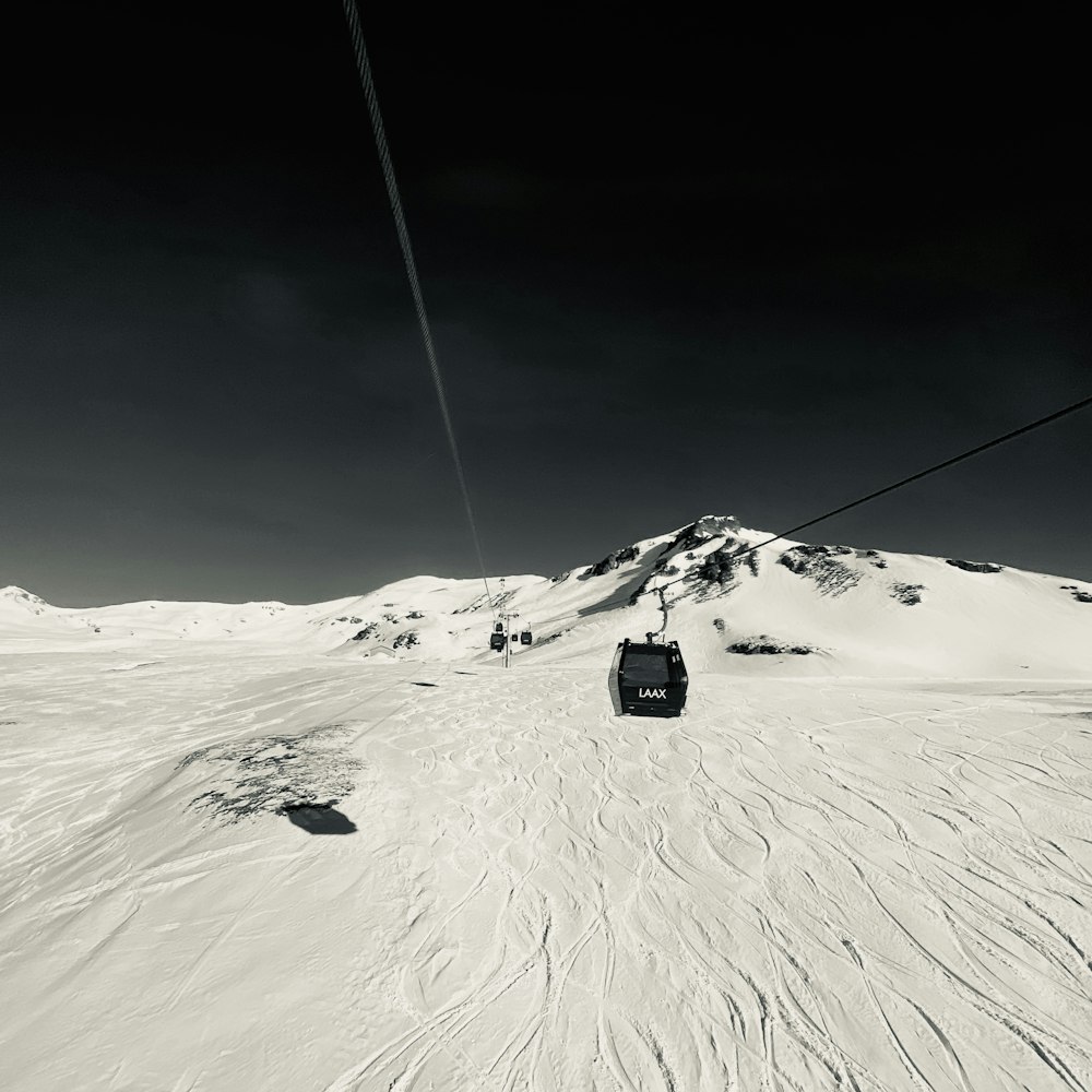 a black and white photo of a ski lift