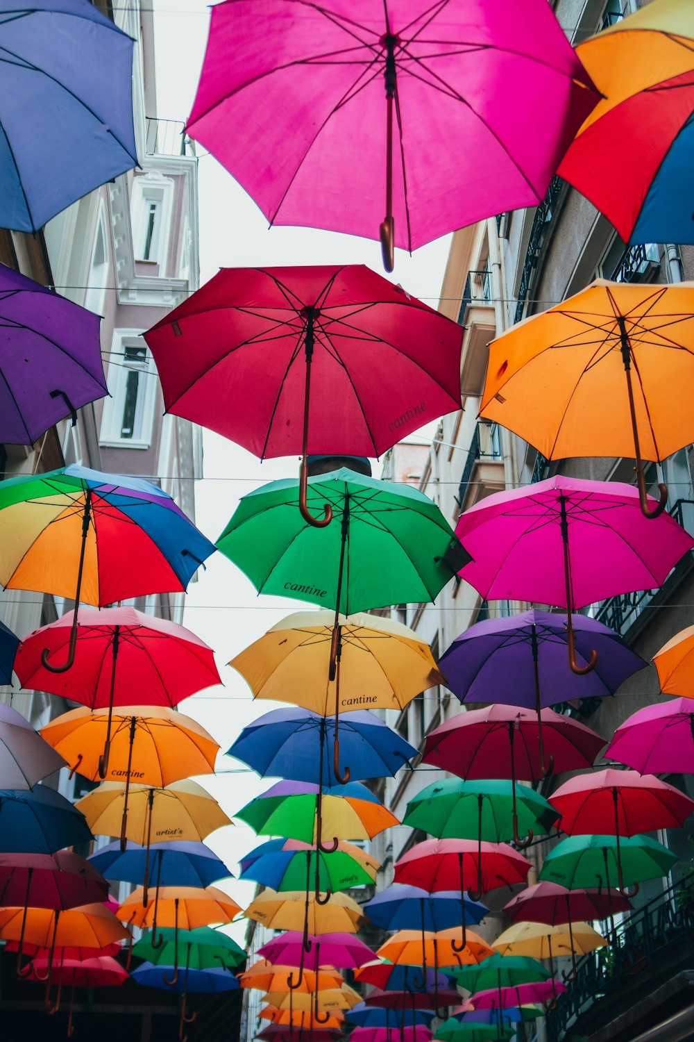 a street filled with lots of colorful umbrellas