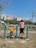 A joyful momma exercising with her children in a park.