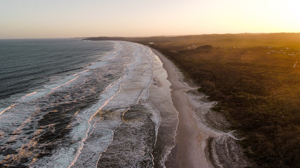 an aerial view of a beach at sunset