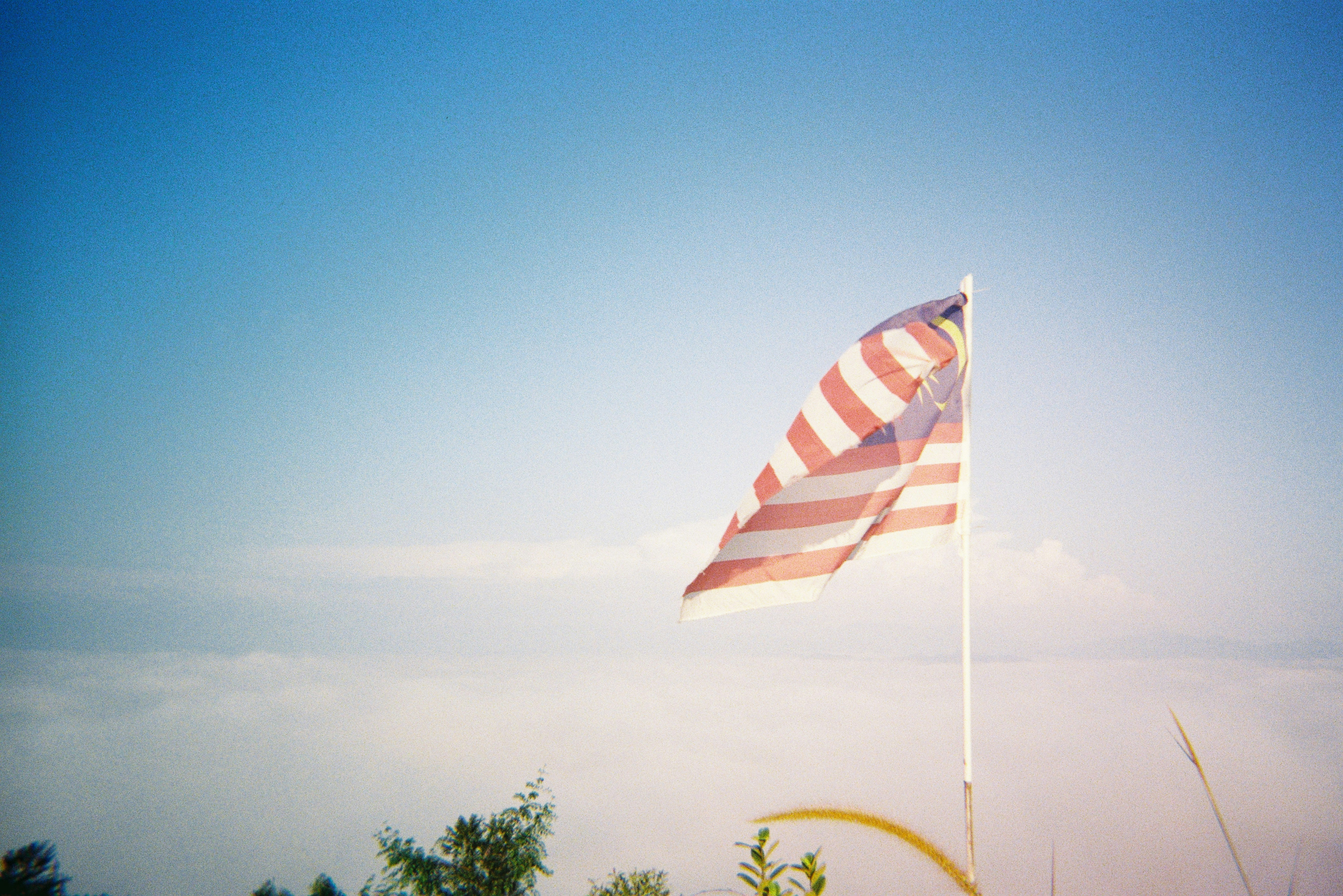 a large american flag flying in the sky