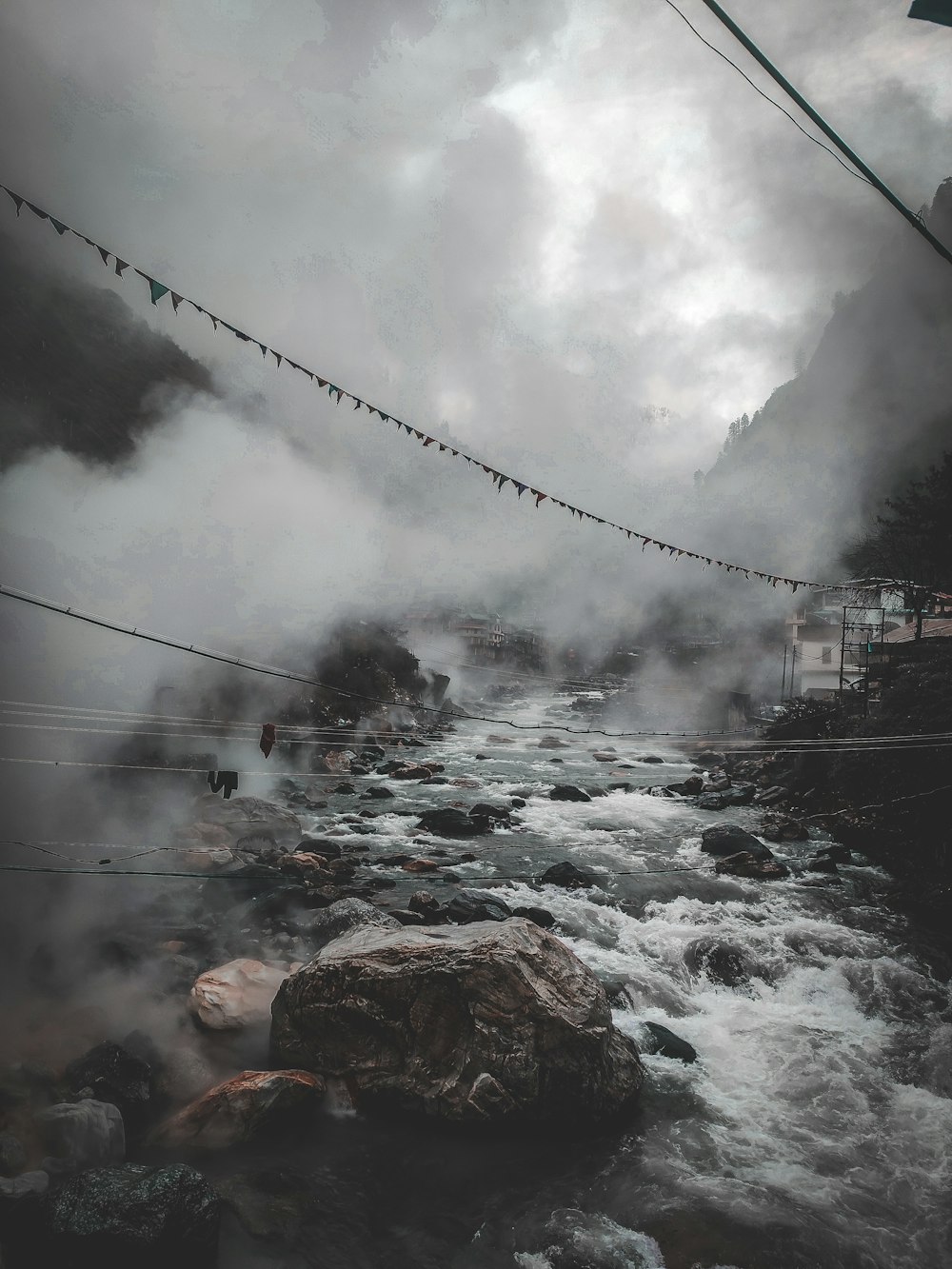 a stream of water surrounded by rocks and power lines