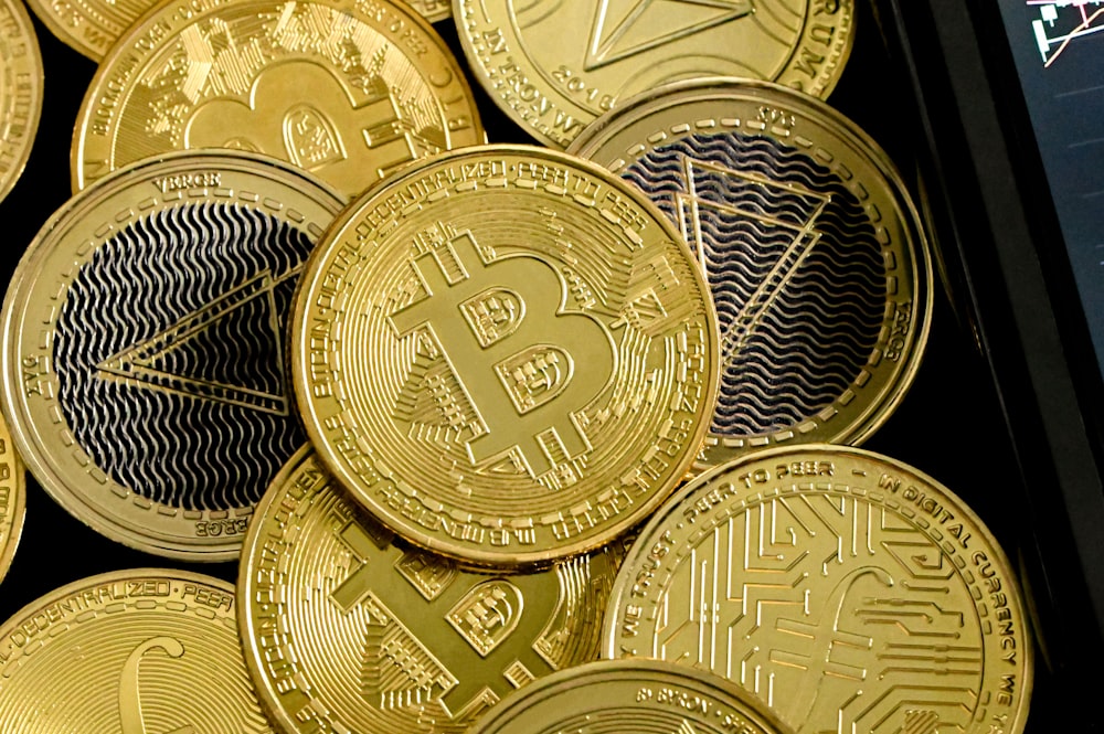 a pile of gold bitcoins sitting on top of each other