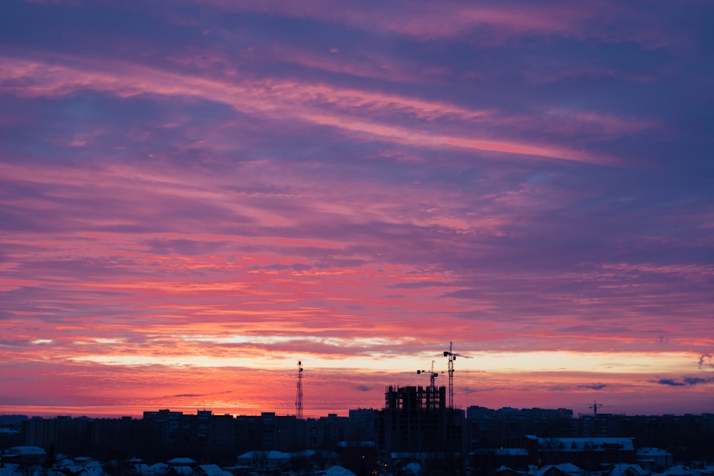 a pink and purple sky over a city