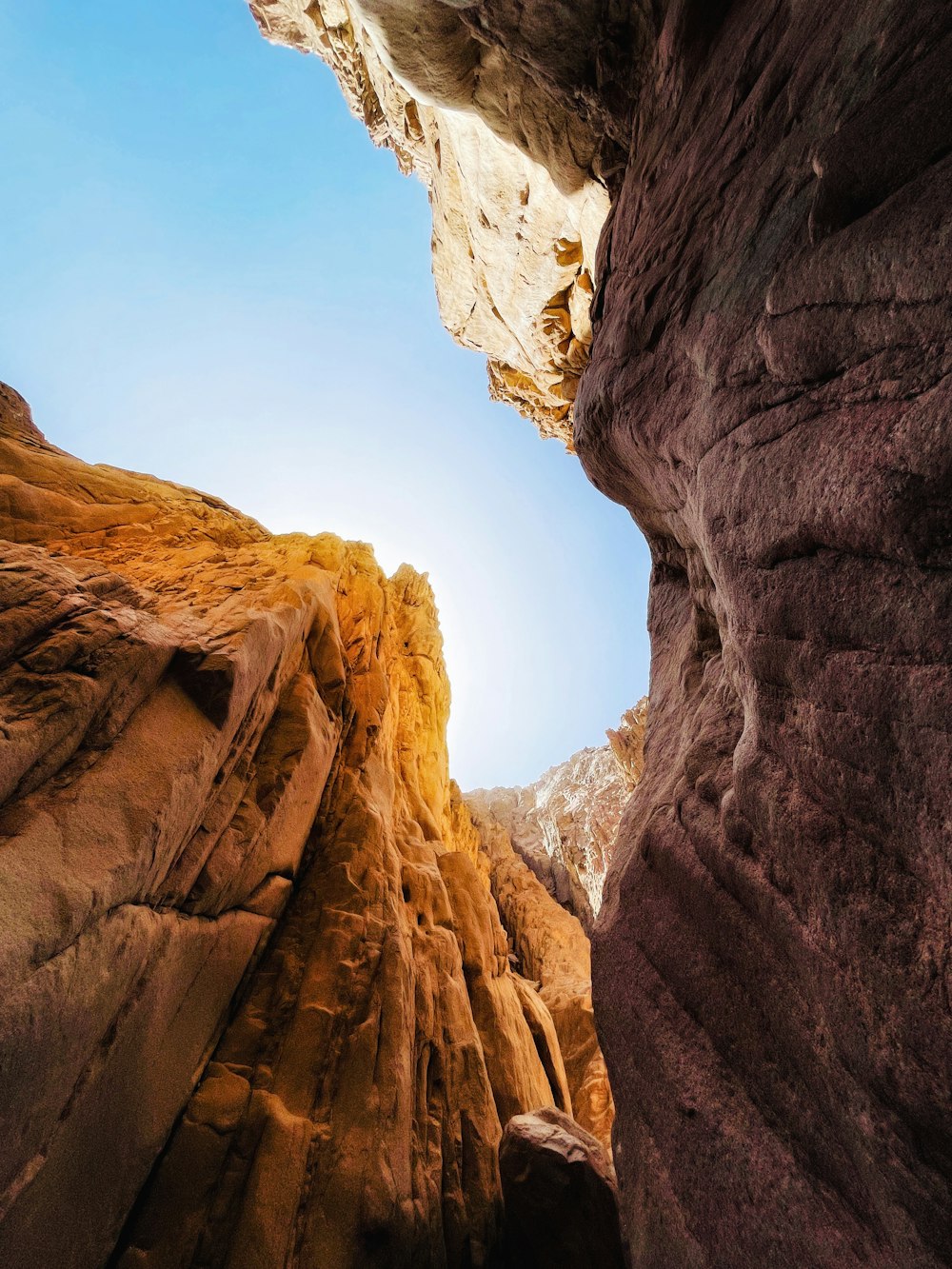 the sun is shining through a narrow canyon