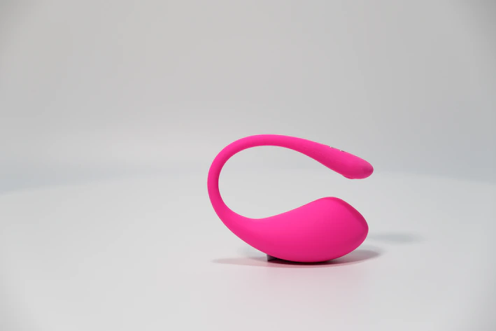 A sleek pastel pink 3D printed jewelry organizer with delicate compartments and rounded edges on a white surface