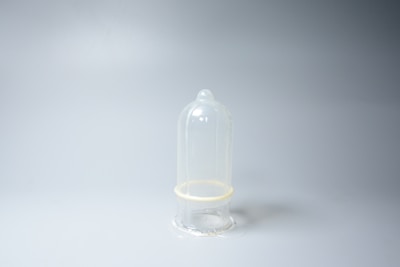 Close-up of branded condom packs neatly arranged with soft lighting on a clean white surface.