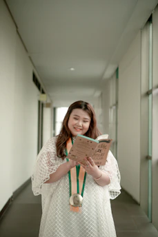A smiling student receiving a scholarship award in a bright classroom.