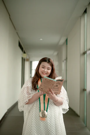 A student proudly holding up a completed project in a bright, colorful school hallway.