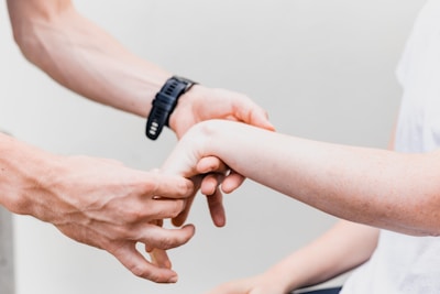 Close-up of a doctor gently examining a patient's wrist with attentive care.