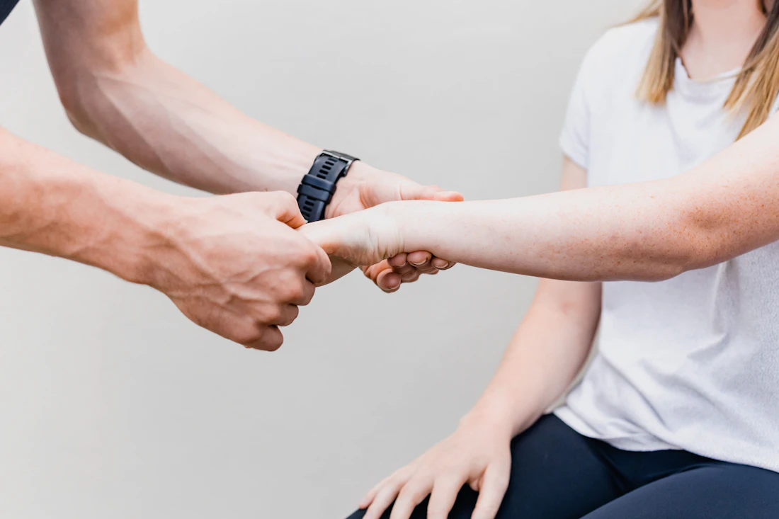Physiotherapist assessing a patient's wrist