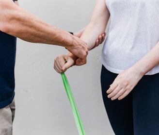 a man and a woman holding a green stick