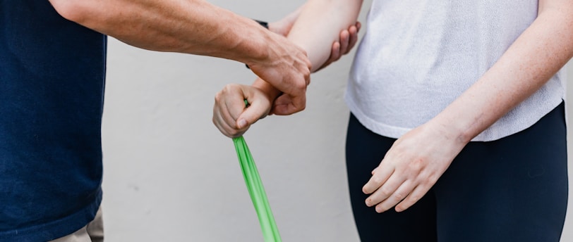 a man and a woman holding a green stick