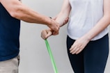 a man and a woman holding a green stick