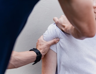 a woman holding onto a man's arm